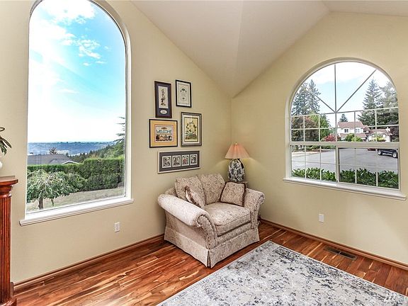 This is your view as you enter this one of a kind custom home! It is ever-changing, gorgeous City of Tacoma Lights at night and daytime Olympic Mountain Views!