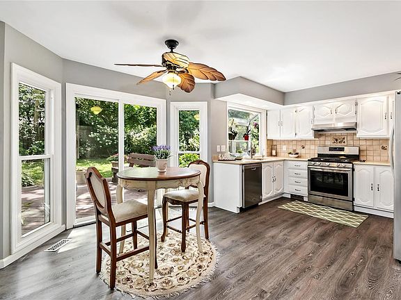The kitchen is loaded with updates from the stainless appliances, quartz countertops, new floors, new lighting and fresh paint. The sliding glass door opens to the beautiful backyard deck.