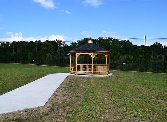 Gazebo and grilles on spacious back lawn.