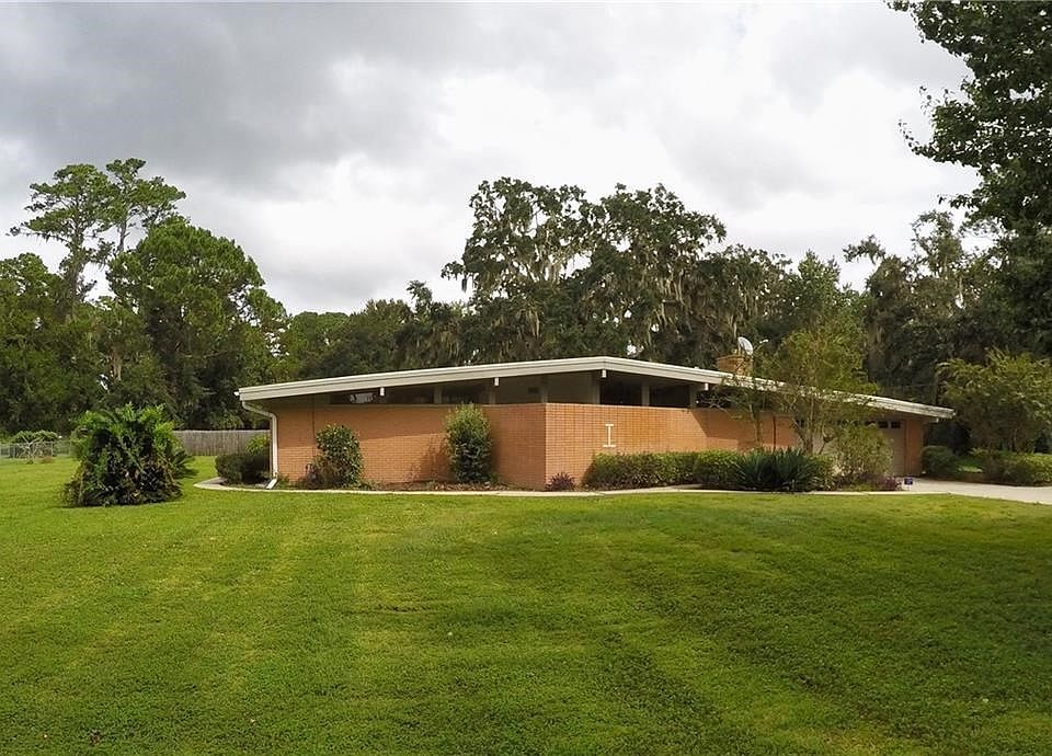 Mid 20th Century 'modern' brick ranch home on HALF AN ACRE zone R9! Private well so there's no water bill and I promise the water tastes great.