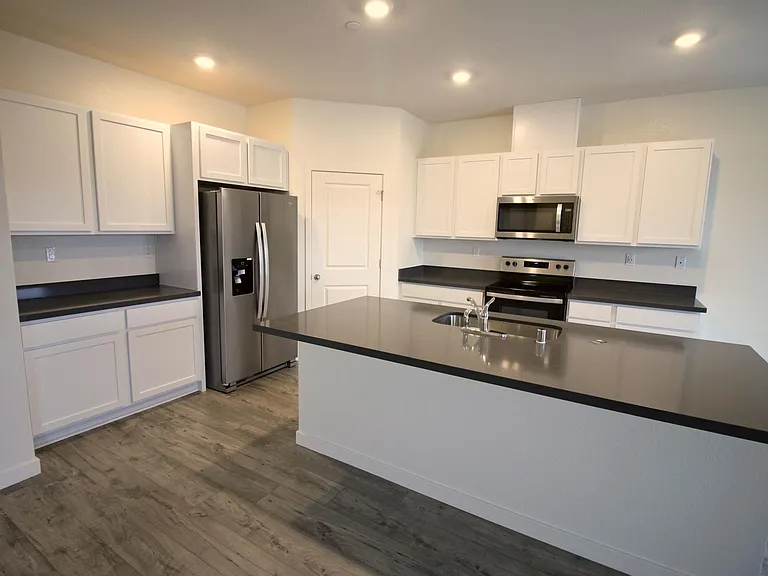 Spacious kitchen with a pantry and lots of storage.
