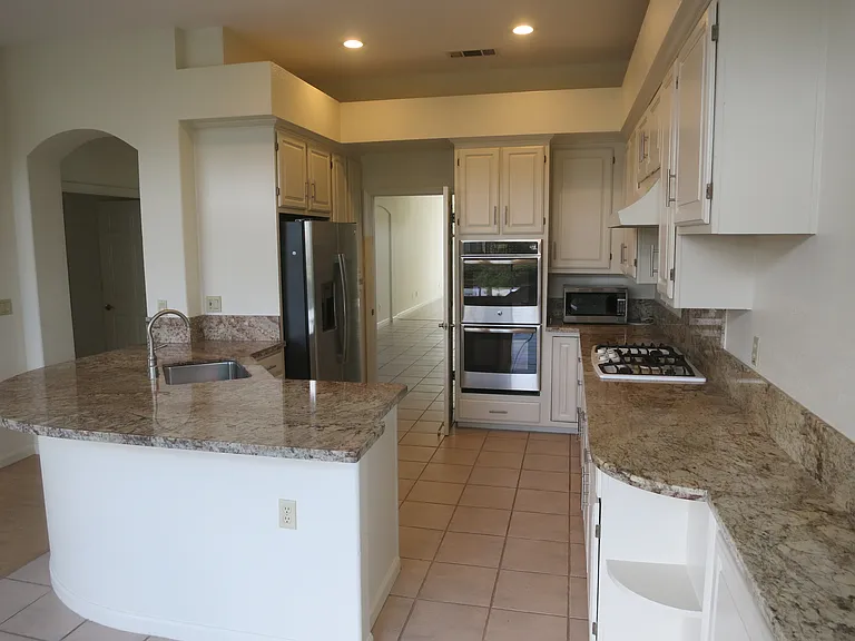 Expansive kitchen with stainless steel appliances