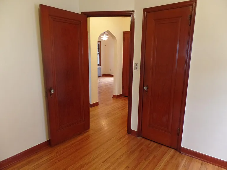 Heading back to the Foyer. Living Room is straight ahead. Kitchen and stairs going to the Upper Bedroom are on the left. Bathroom and Front Bedroom on the right.