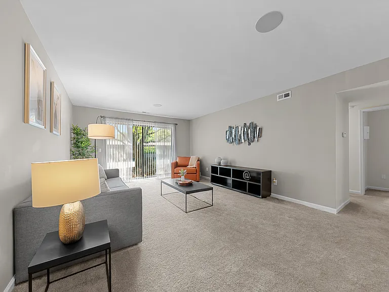 Spacious Living Room with Sliding Glass Door at Lakeside Village Apartments Clinton Township MI