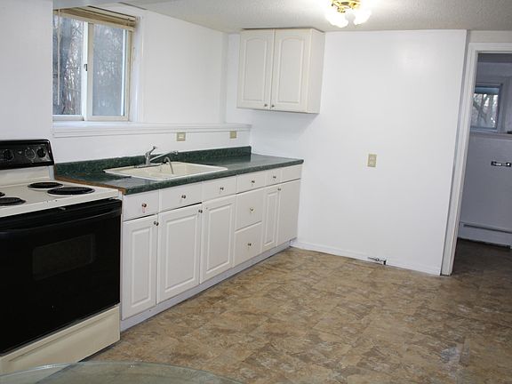 Kitchen with bathroom door visible
