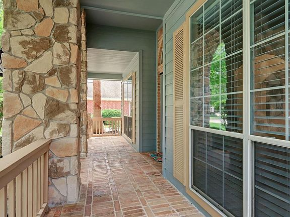 Enjoy this shaded, breezy front porch.