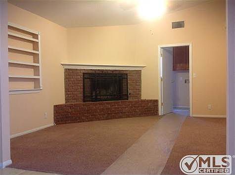 Separate family room with brick fireplace and raised hearth