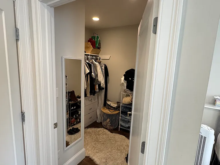 Walk-in closet in master bedroom suite.