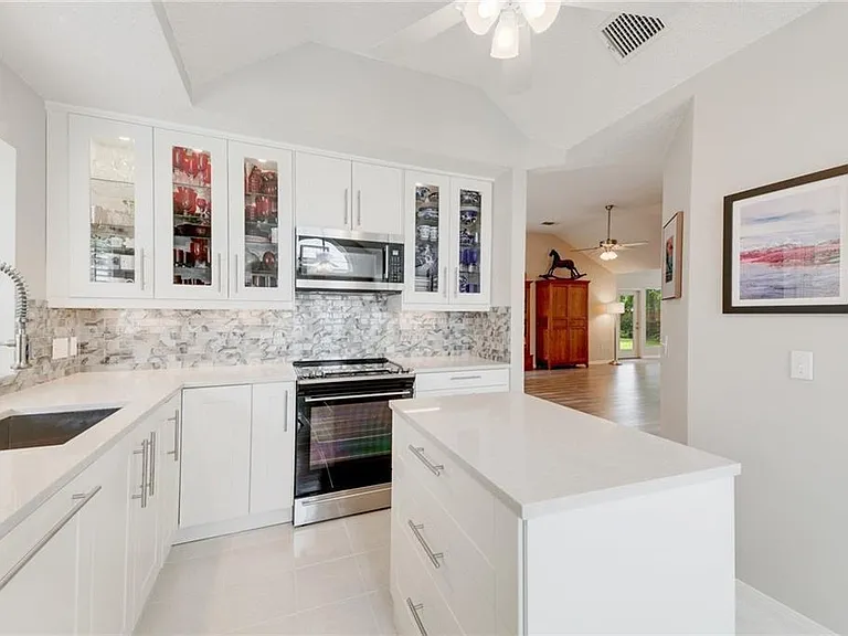 Beautiful, clean and functional kitchen with utility island.