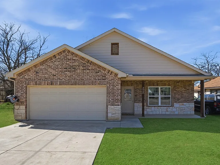 Brick and stone facade with an attached two-car garage