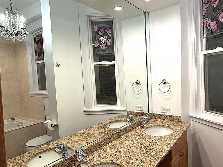 Double sink vanity. Granite top. Full size mirror.