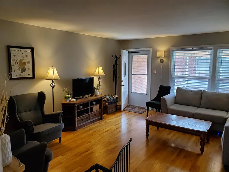 Living room with Hardwoods and newer windows and doors