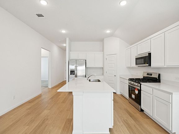 Kitchen in the Redbud home plan by Trophy Signature Homes - REPRESENTATIVE PHOTO