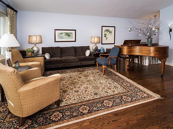 Beautiful hardwood floors are accented with white trim.