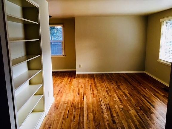 Living area, built in shelving and diningroom