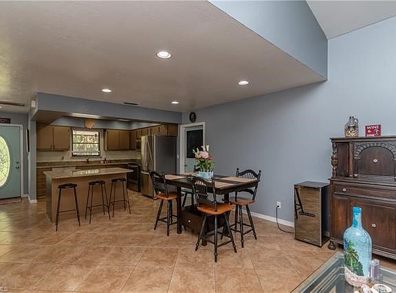 Entry door into open kitchen, dining and living area.
