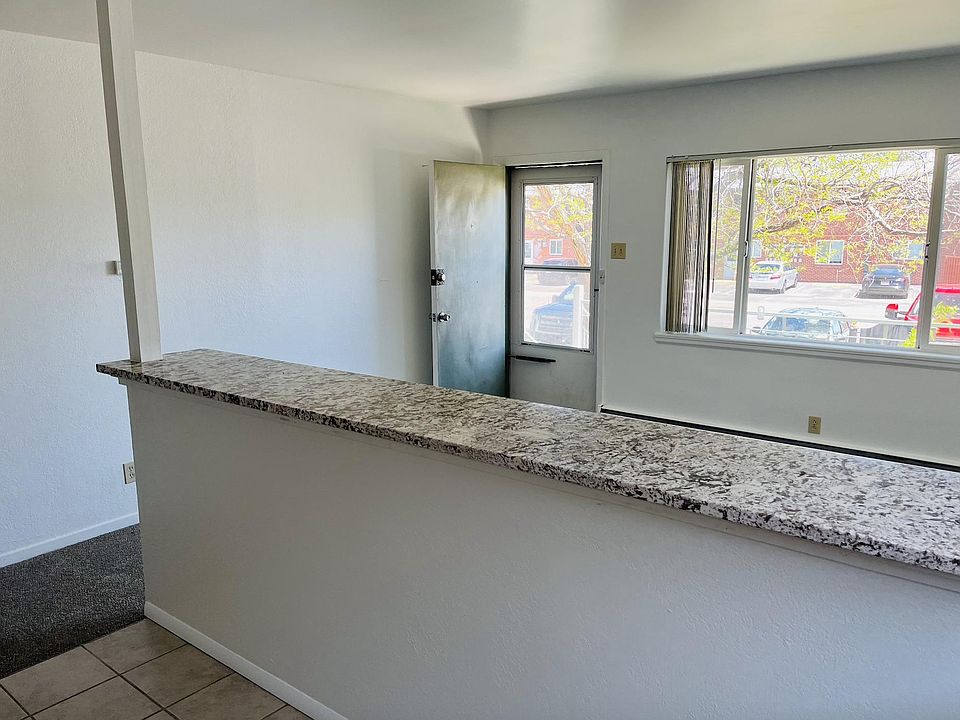 Other side of Kitchen island and showing living room and front door