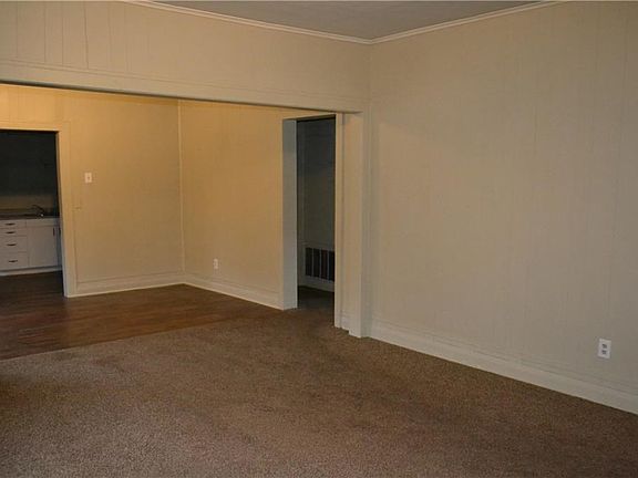 Living room with view of dining area and kitchen.