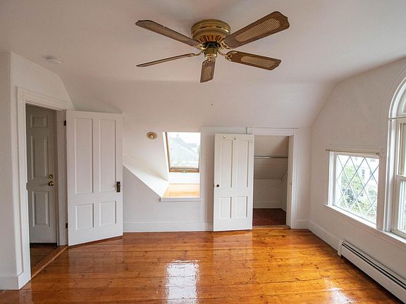 Bedroom 1 with closet and window seat.