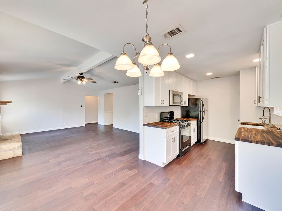 Modern Kitchen: featuring beautiful butcher block countertops, crisp white shaker style cabinets, and sleek stainless steel appliances.