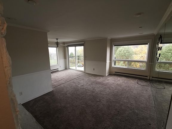 Living Room has bay windows and opens out to deck.