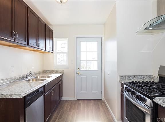 kitchen includes fridge, has door to back yard