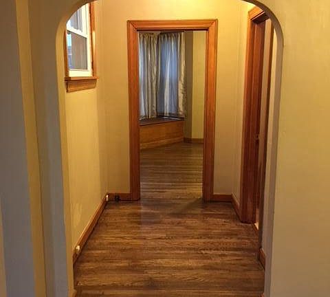 Hallway with view to large bedroom and bathroom
