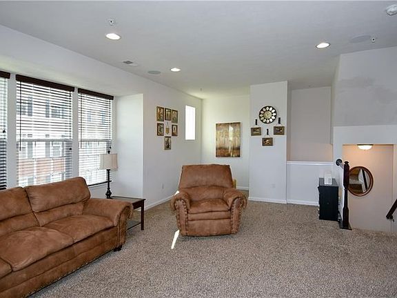 The living room is further enhanced by overhead lighting adding a warm ambience to this space.
