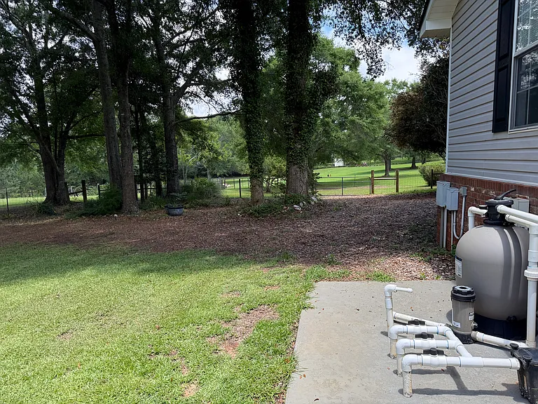Wide gate with access to the back yard.