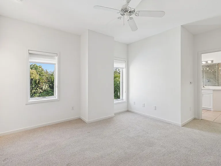 Master Bedroom with Tall Casement Windows overlooking Community Pool and Laurel Park.