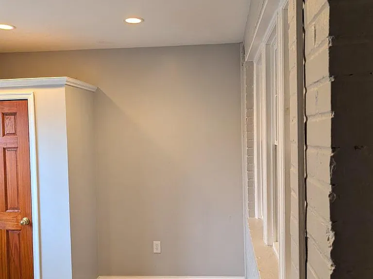 Flex space or possible bedroom leads to rear exit.