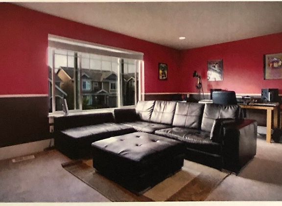 Large upstairs bedroom (size similar to master bedroom's size). Room walls have been repainted with beige color. Window overlooking street in front of house