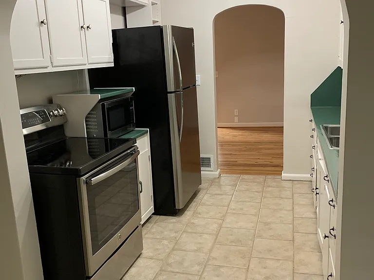 Included kitchen appliances with archways throughout the main section of the house