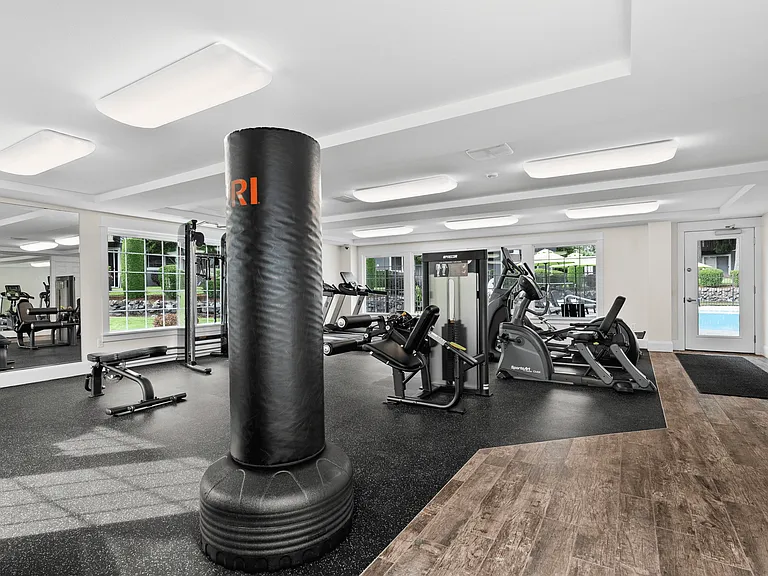 Spacious fitness center with full-body workout equipment and natural light.