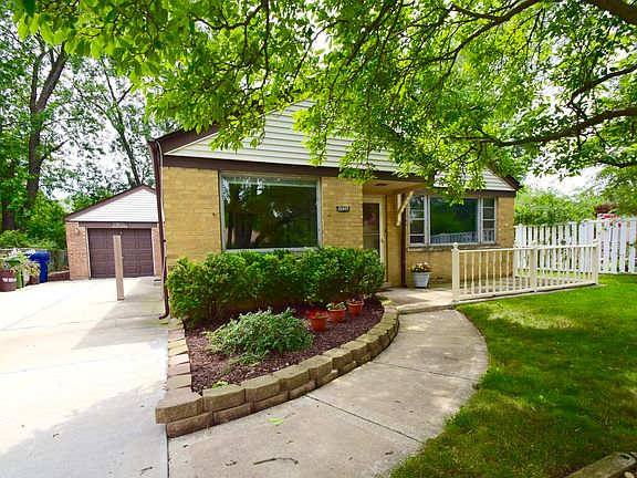 Front of 10947 Keeler with concrete side drive and attached garage.
