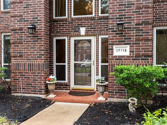 Lovely covered porch, handsome red brick and new front door with screened storm door.