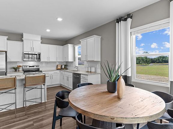 Dining Area conveniently next to Kitchen. Model Home Representation.
