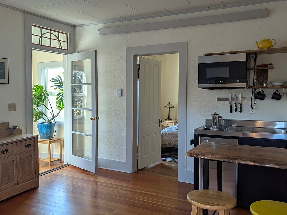 From the living room to the kitchenette and bedroom with sun porch entrance. Original fir floors and high ceilings help to keep the apartment bright and airy.