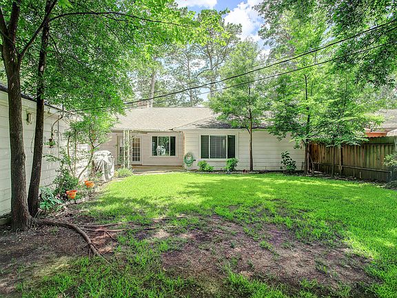 Backyard with covered patio with fan. Built-in gas grill (connected to house natural gas).