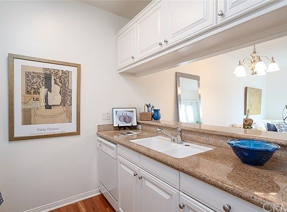 Beautiful Granite Counter Top with White Cabinetry and Appliances