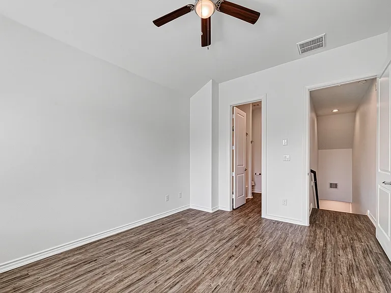 Spacious third-floor primary suite with high ceilings.