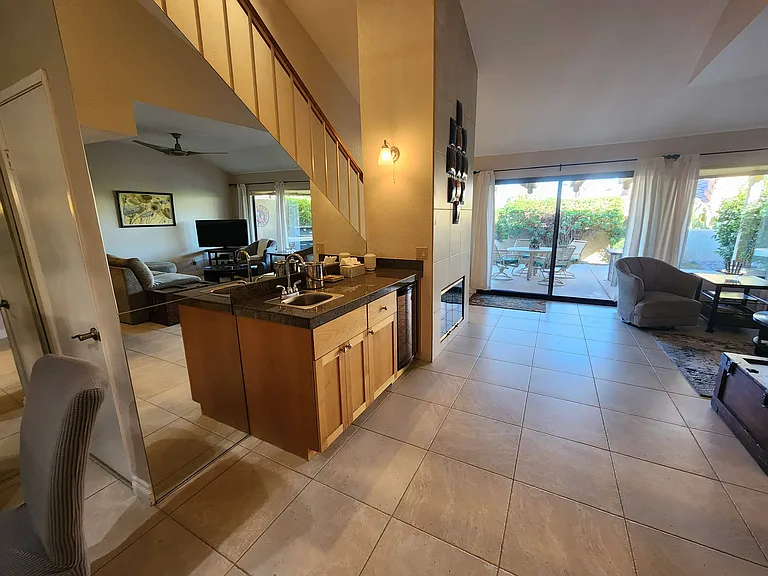 Large living area with bar, dining room & fire place