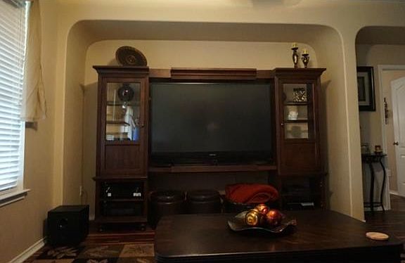 Living room with nice size nook for entertainment center.