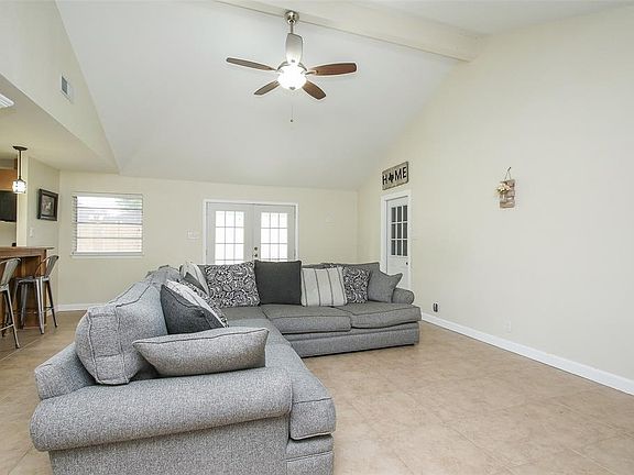 Large family/living room with vaulted ceilings. Open to the kitchen and dining room.