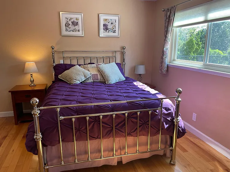 Beautiful, comfortable queen bed with foam topper, down duvet cover, end tables and lamps.