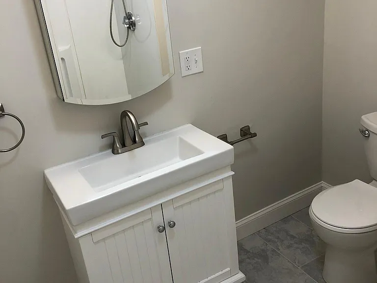 New toilet, floors, vanity, mirror with storage.