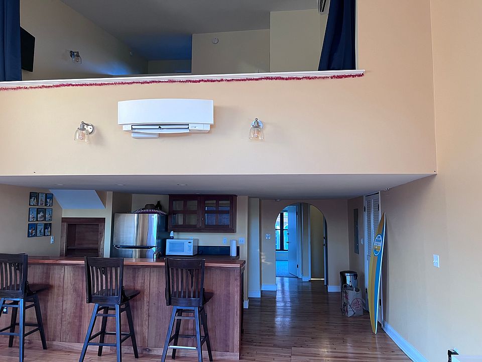 View of kitchen and loft bedroom upstairs, as viewed from living room with back to the harbor.