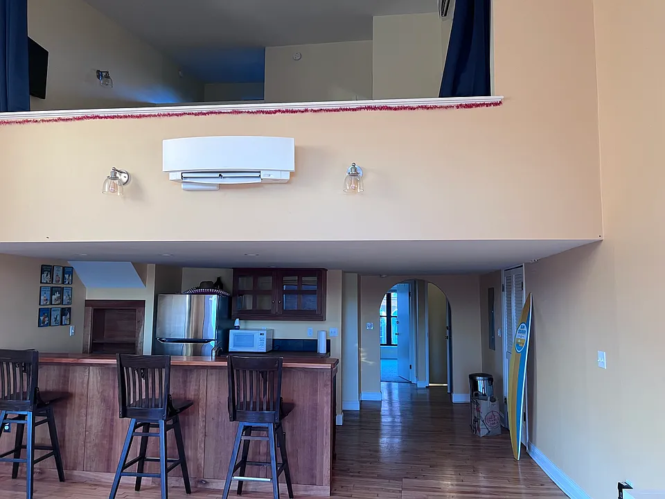 View of kitchen and loft bedroom upstairs, as viewed from living room with back to the harbor.