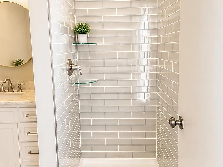 Master en suite bathroom with tile shower