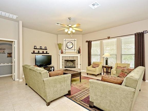 Large bright family room with fireplace and view of backyard.